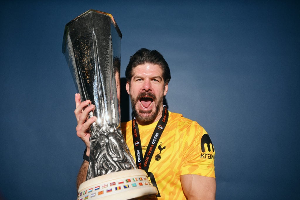 Tottenham Hotspur goalkeeper Fraser Forster celebrates holding the Europa League trophy
