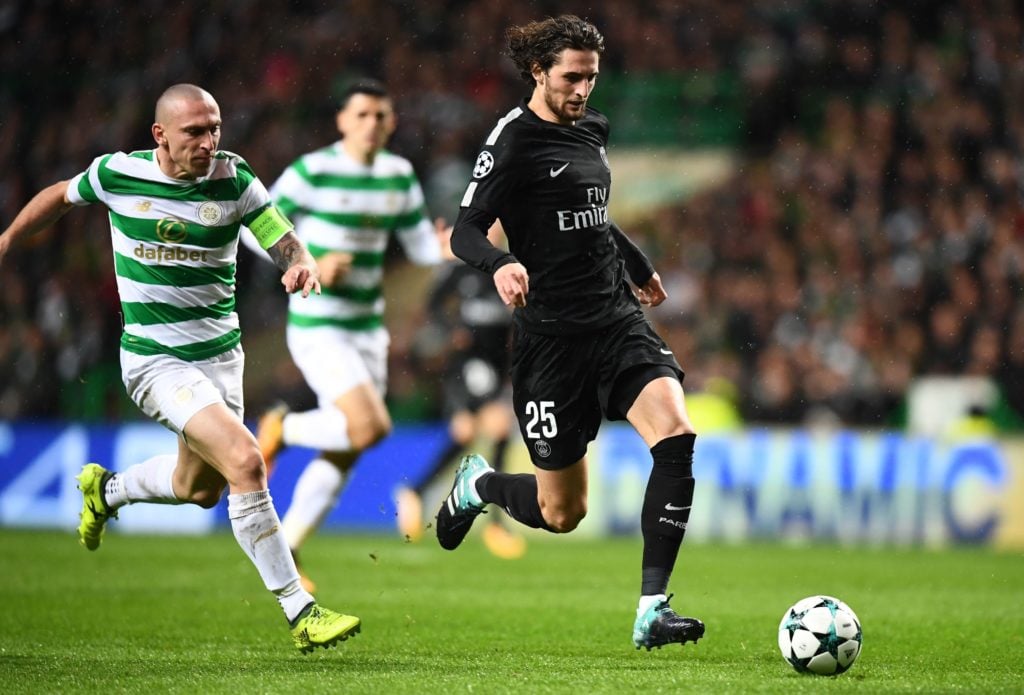 Paris Saint-Germain's French midfielder Adrien Rabiot (R) runs away from Celtic's Scottish midfielder Scott Brown during the UEFA Champions League Group B football match between Celtic and PSG