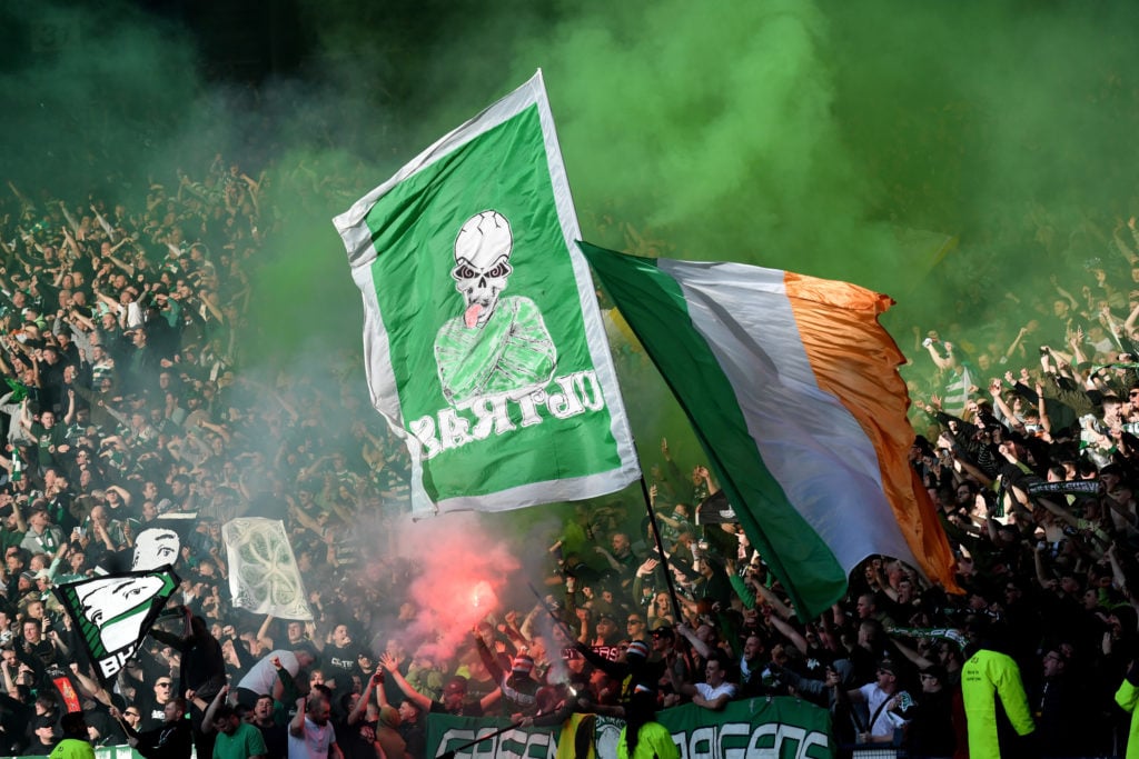 Celtic fans celebrate with flags and flares after Kyogo Furuhashi of Celtic scores the team's first goal during the Viaplay Cup Final between Rangers and Celtic at Hampden Park