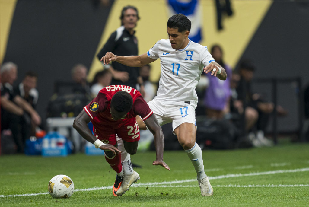 Luis Palma #17 of Honduras fouls Richie Laryea #22 of Canada while battling for the ball during the first half of 2025 Concacaf Gold Cup Group B action at BC Place