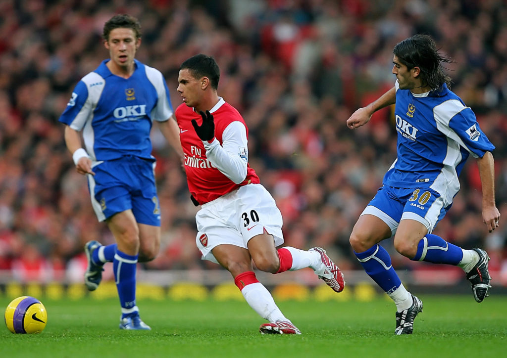 Arsenal forward Jeremie Aliadiere challenges for the ball against two Portsmouth players during a Premier League game