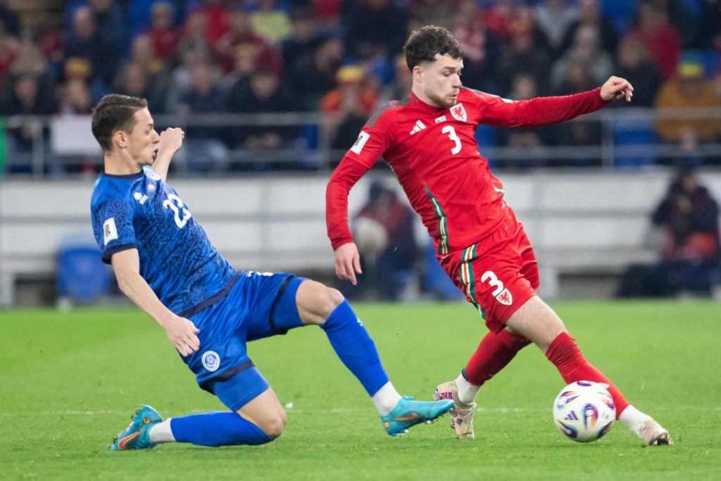 Islam Chesnokov challenges for the ball during Kazakhstan's clash against Wales.