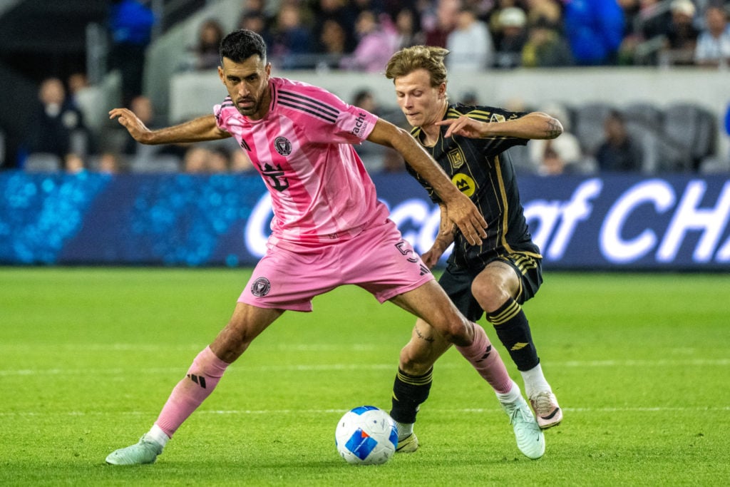 Sergio Busquets #5 of Inter Miami battles Odin Thiago Holm #80 of Los Angeles FC during the second half of the 2025 Concacaf Champions Cup match at BMO Stadium