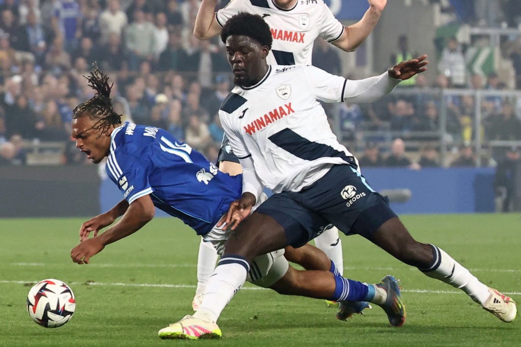 Etienne Youte makes a tackle during Le Havre vs Strasbourg