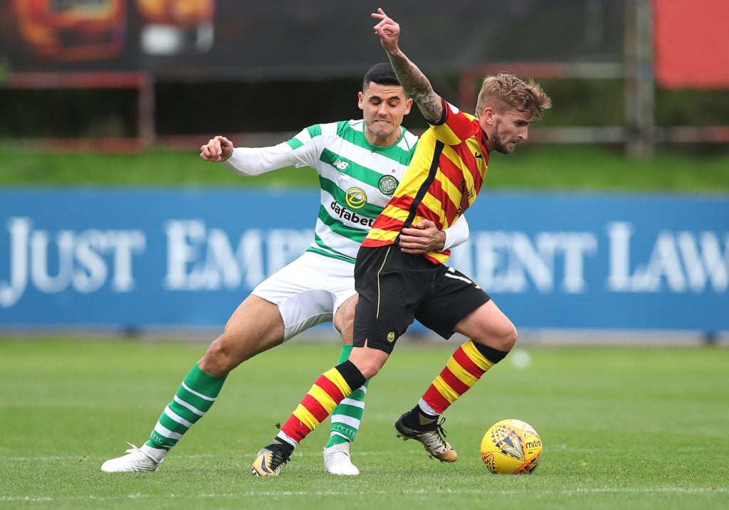 Tom Rogic battles with a Partick Thistle midfielder during the Scottish Cup clash
