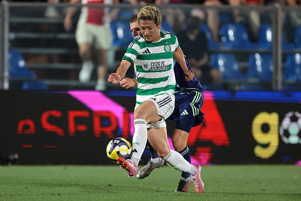 Daizen Maeda shrugs off a challenge from an Ajax defender during the Como Cup