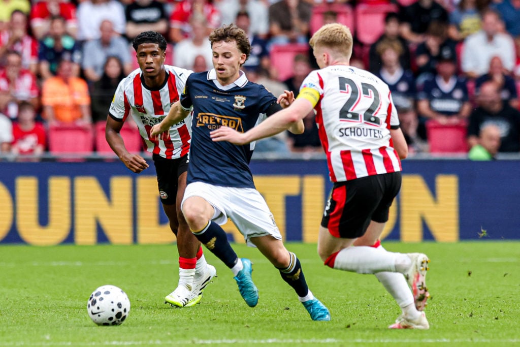 Jakob Breum of Go Ahead Eagles dribbles between Ryan Flamingo of PSV Eindhoven and Jerdy Schouten of PSV