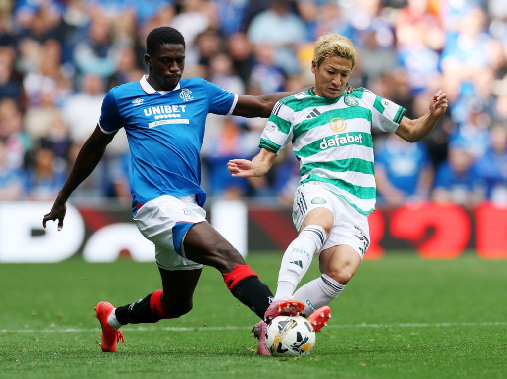Daizen Maeda of Celtic is challenged by Nasser Djiga of Rangers during the Premier League match between Rangers and Celtic at Ibrox Stadium