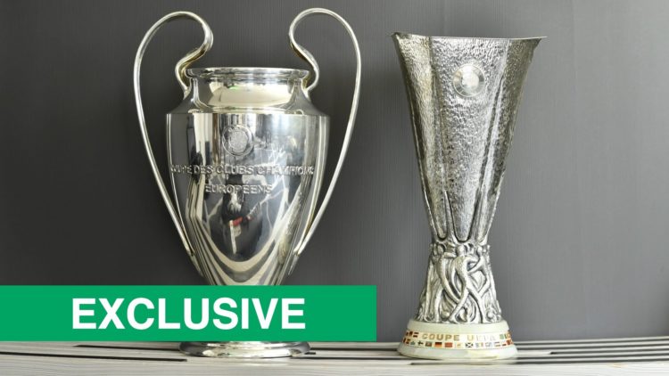 Detailed view of the Champions League and Europa League trophies side by side