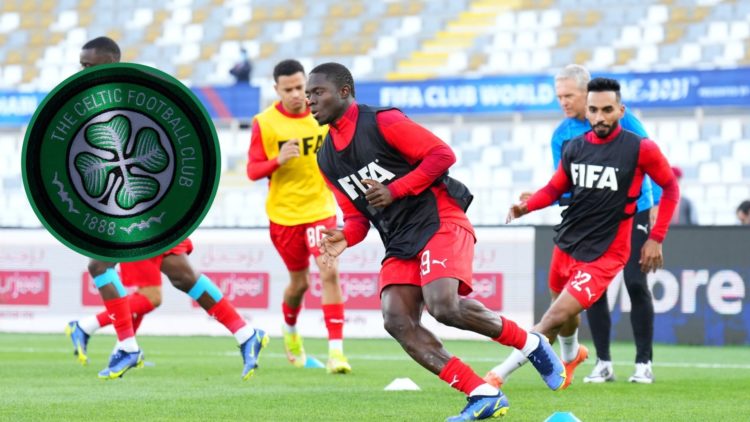 Oumar Traore of Al Jazira warms up before the 5th place match vs Monterrey at the Club World Cup in 2021, an inset of the Celtic badge