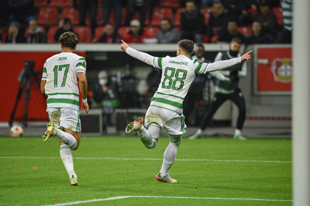 Celtic's Croatian defender Josip Juranovic (R) celebrates the 1-1 during the UEFA Europa League Group G football match Bayer 04 Leverkusen v Celtic