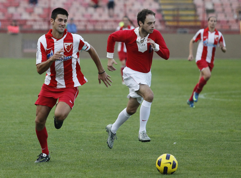 Novak Djokovic (L) in action during humanitarian match "Battle for babies" Novak Djokovic play for FC Red Star on September 27, 2011