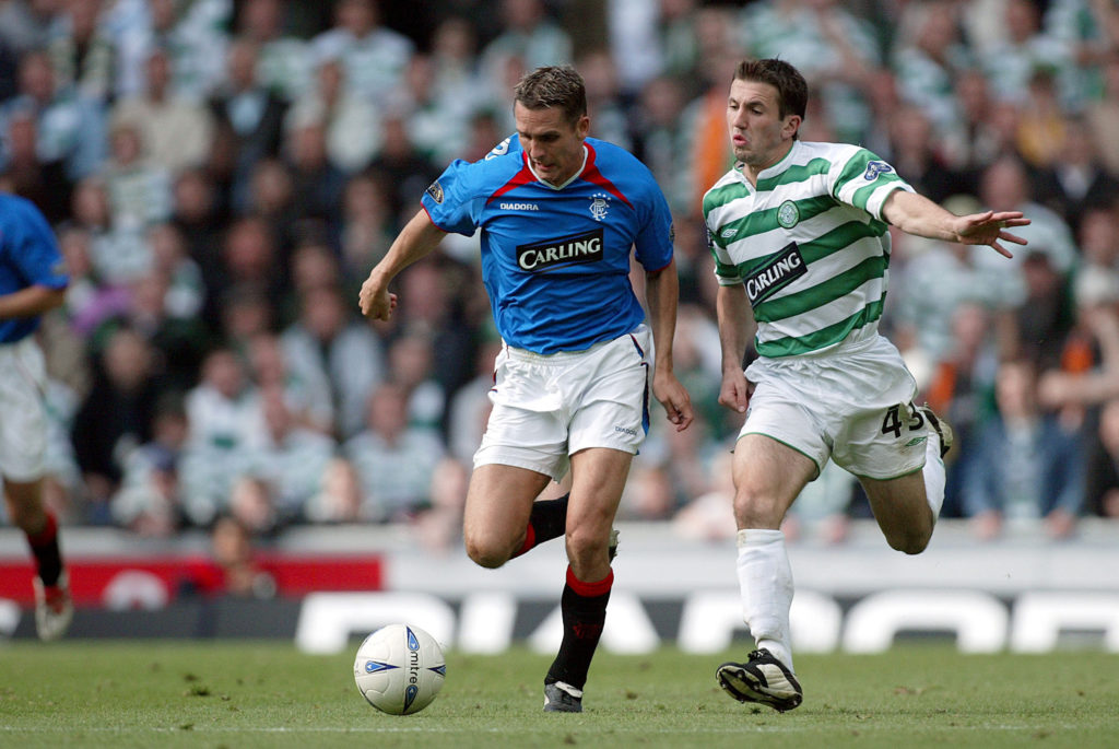 Peter Lovenkrands of Glasgow Rangers and Liam Miller of Glasgow Celtic challenge during the Scottish Premiership match between Glasgow Rangers and Glasgow Celtic at Ibrox Stadium