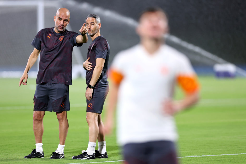 Man City manager Pep Guardiola is in conversation with assistant Carlos Vicens