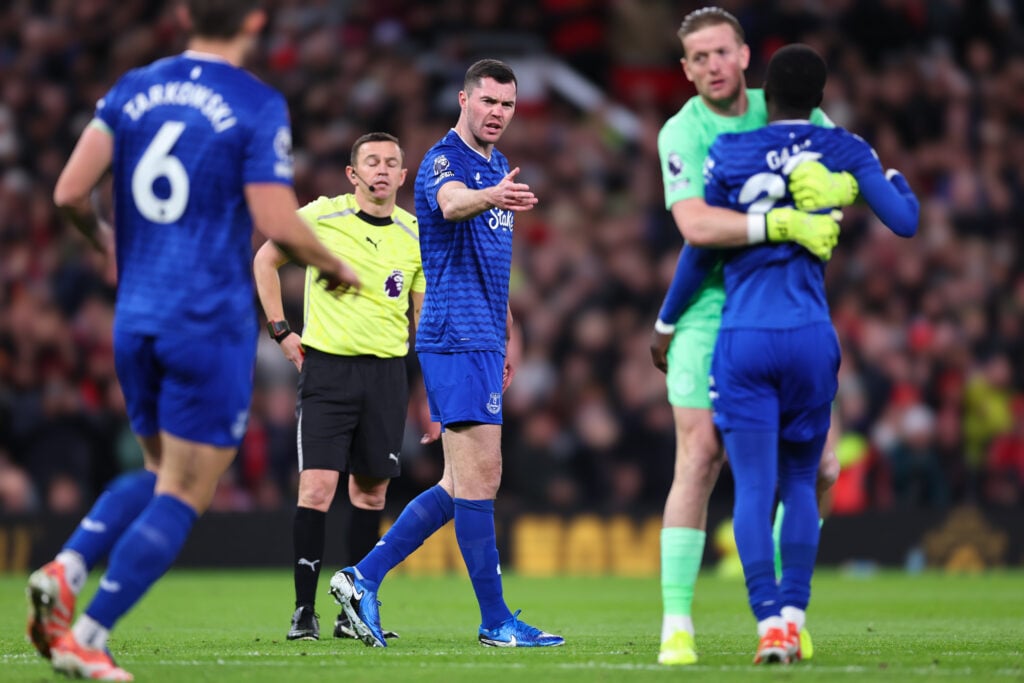 Idrissa Gueye is escorted away by Jordan Pickford after getting sent off for striking Everton teammate Michael Keane against Manchester United.