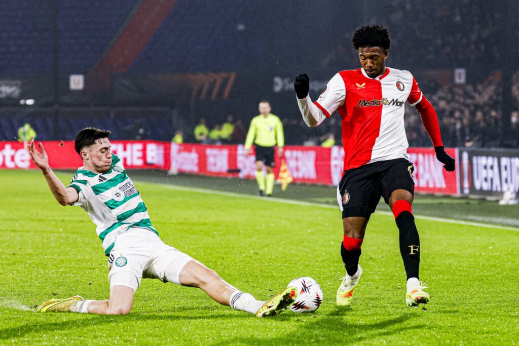 Colby Donovan tackles a Feyenoord player in the Europa League