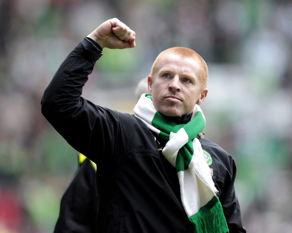 Celtic's manager, Neil Lennon, pumps a fist in the air after his team wins 4-0 in their Scottish Premier League football match against Motherwell
