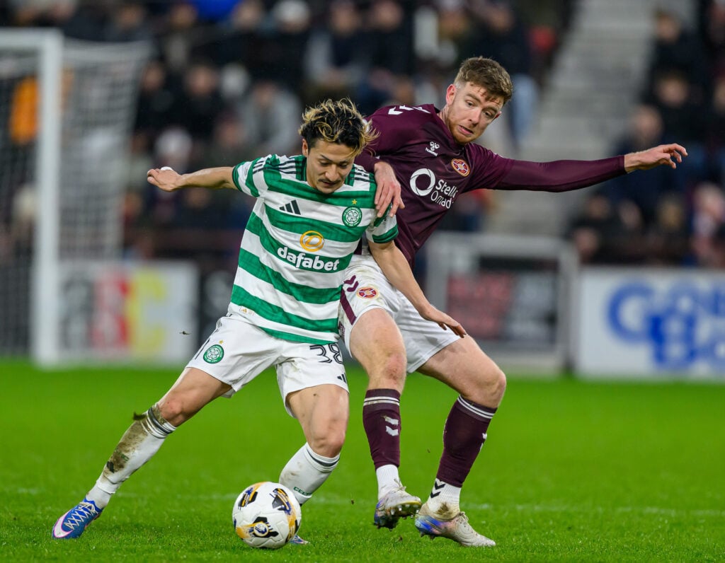 Daizen Maeda (L) of Celtic holds off Stuart Findlay of Hearts