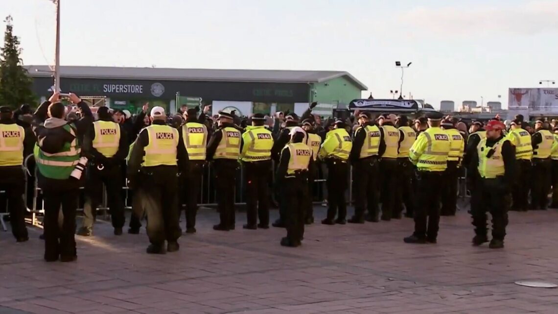 Celtic fans congregate outside the stadium and are met by police