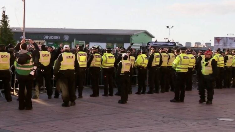 Celtic fans congregate outside the stadium and are met by police
