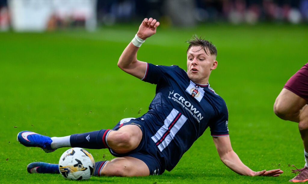 Luke Graham of Dundee makes a slide tackle during the Premier League match between Dundee and Heart of Midlothian