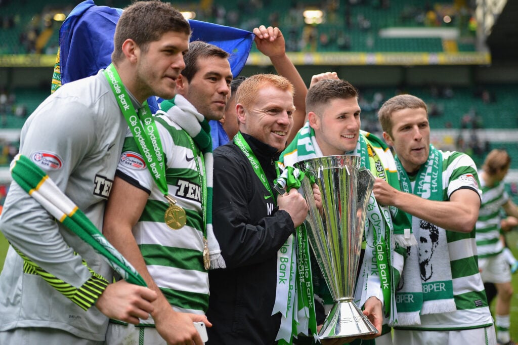 Neil Lennon, coach of Celtic, holds the Clydesdale Bank Premier League trophy