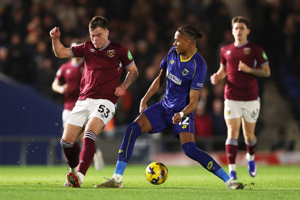 Daniel Cummings of West Ham United battles for possession with Alistair Smith of AFC Wimbledon during the Vetru Trophy match between AFC Wimbledon v West Ham United U21 at The Cherry Red Records Stadium