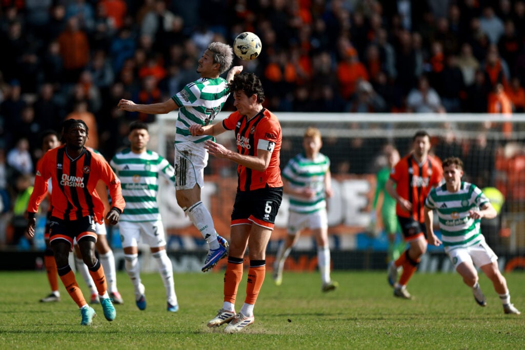 Daizen Maeda of Celtic battles for a header with Ross Graham of Dundee United during the William Hill Premiership match between Dundee United and Celtic