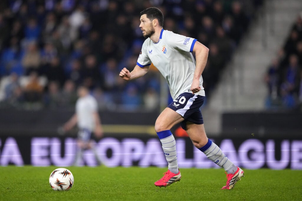 Scott McKenna of GNK Dinamo dribbles the ball in the first half of the UEFA Europa League 2025/26 Knockout Play-off Second Leg match between KRC Genk and GNK Dinamo