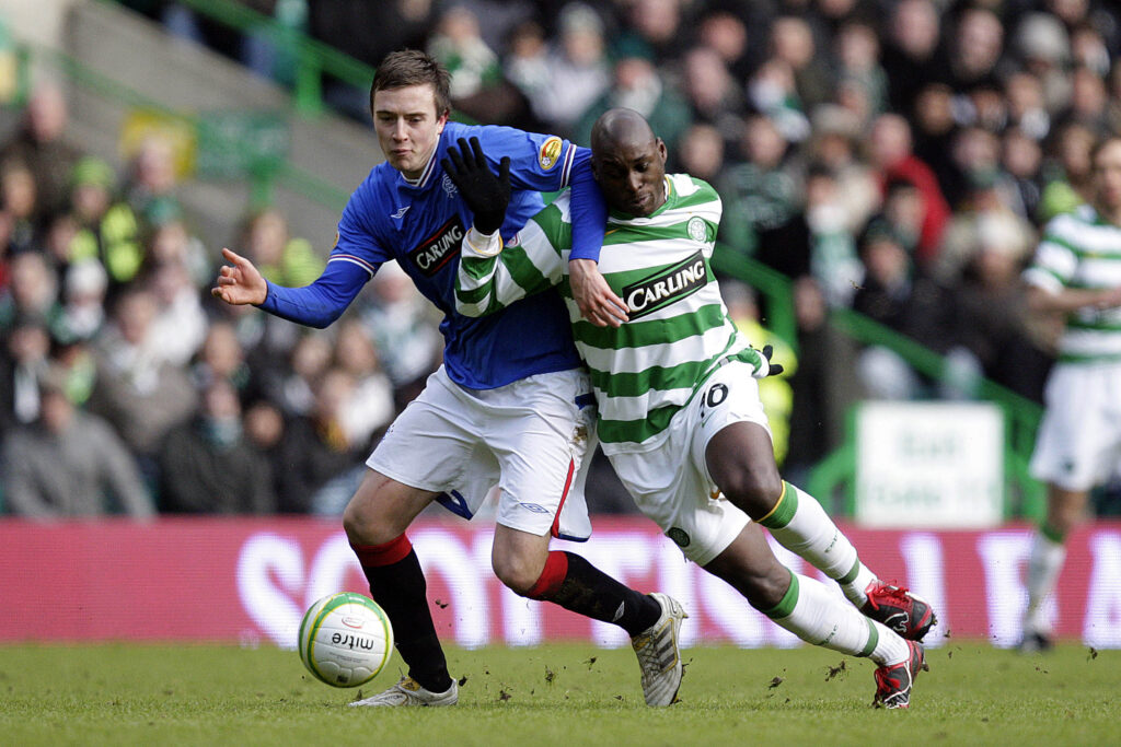 Celtic's French striker Marc-Antoine Fortune (R) vies with Rangers Danny Wilson (L) during a Scottish Premier League football match at Celtic Park