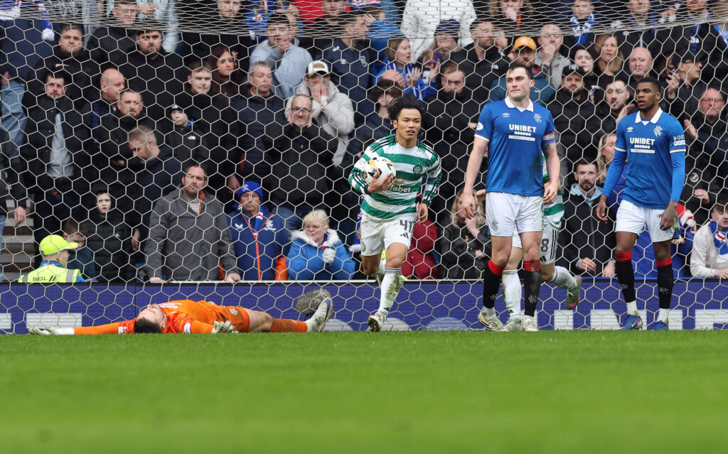 Celtic's Reo Hatate picking up the ball after scoring against Rangers in the Scottish Premiership