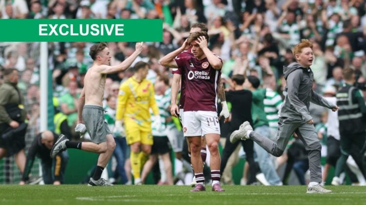 Heart of Midlothian players are seen at full time as Celtic fans invade the pitch during the William Hill Premiership match between Celtic and Hear...